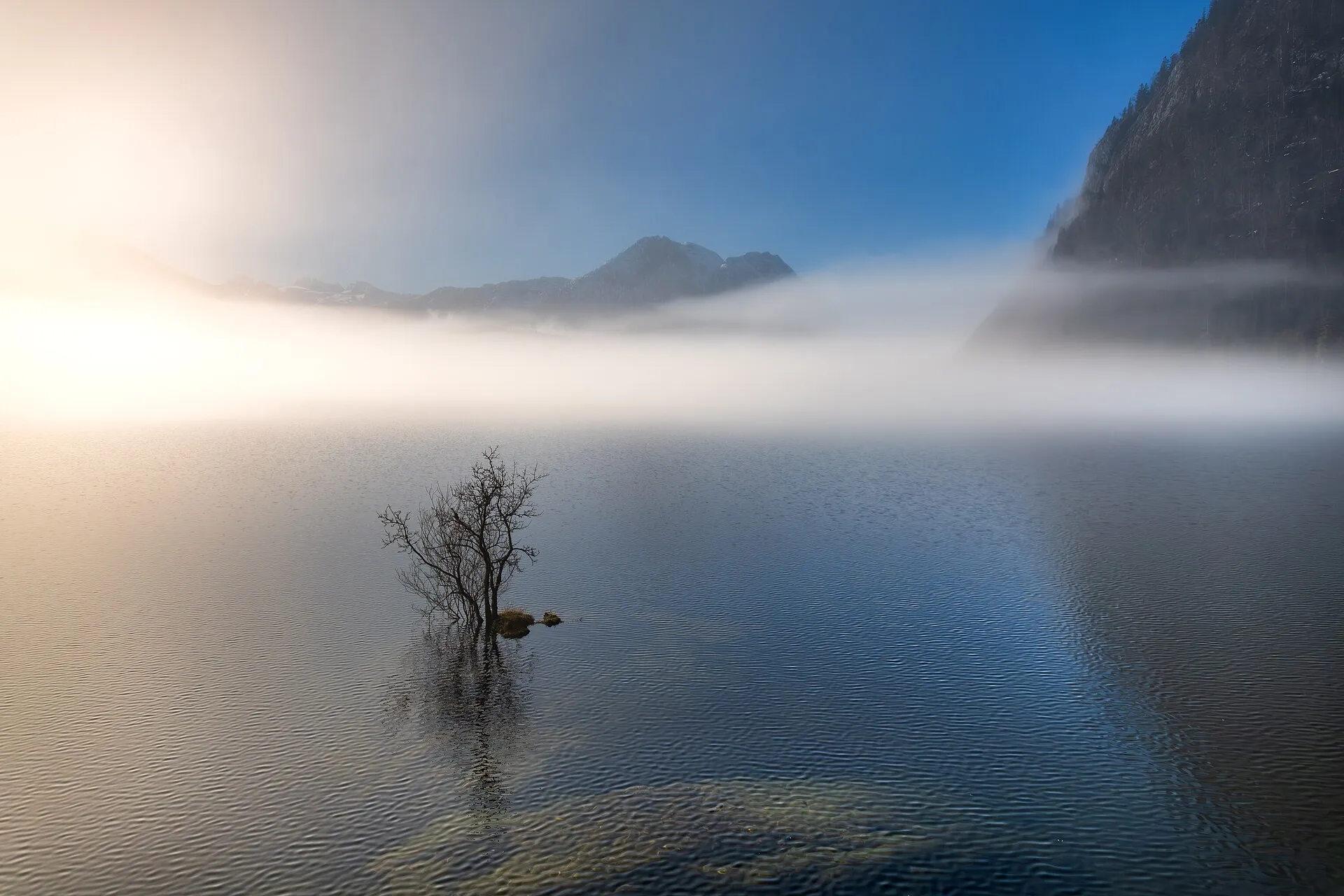 Nebel über dem Altausseer See zwischen Bergen